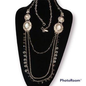 Ann Taylor gold-tone, long tired necklace.